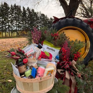 gift basket full of local products in front of our farm's tractor
