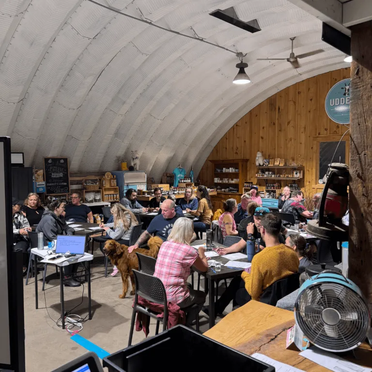 Corporate team participating in a training and team-building session inside the farm market store at Udderly Ridiculous Farm Life