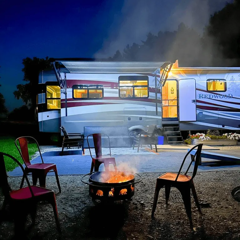 Farm Glamping RV lit up at night with a cozy fire pit in the foreground, captured by lokiexplore on Instagram at Udderly Ridiculous Farm Life.