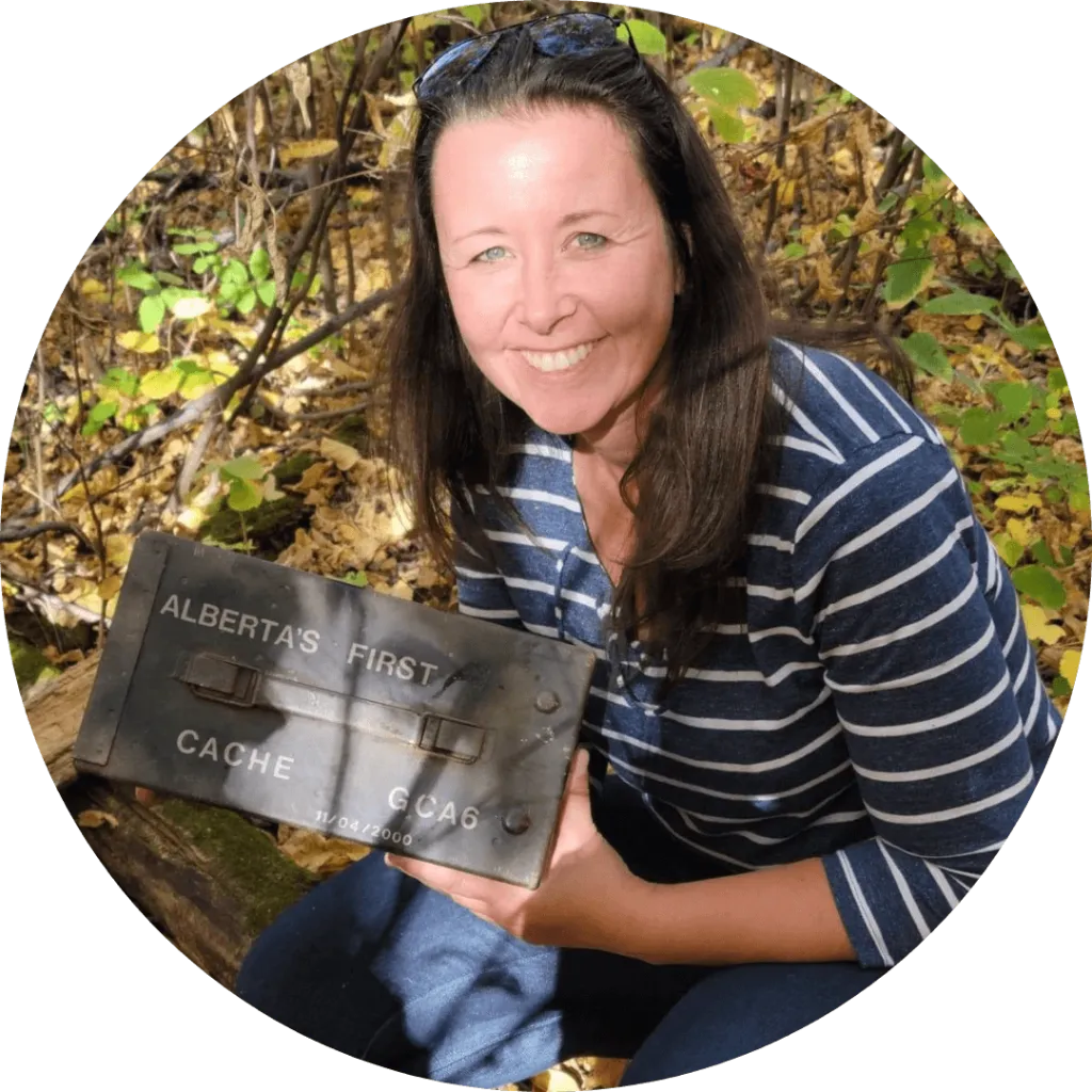 Jennifer Veitch holding a children’s book and smiling with a llama in the background at Udderly Ridiculous Farm Life.